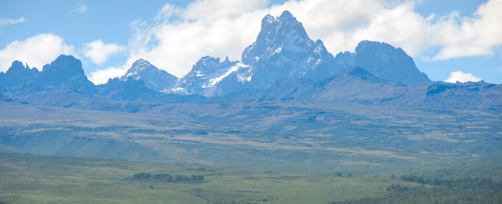 Mount Kenya sett på avstånd med grönt landskap framför det
