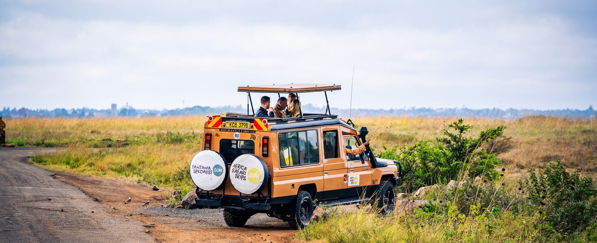 Safari-jeep med öppet tak på savannen i Uganda